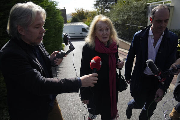 French author Annie Ernaux speaks to media as she leaves...